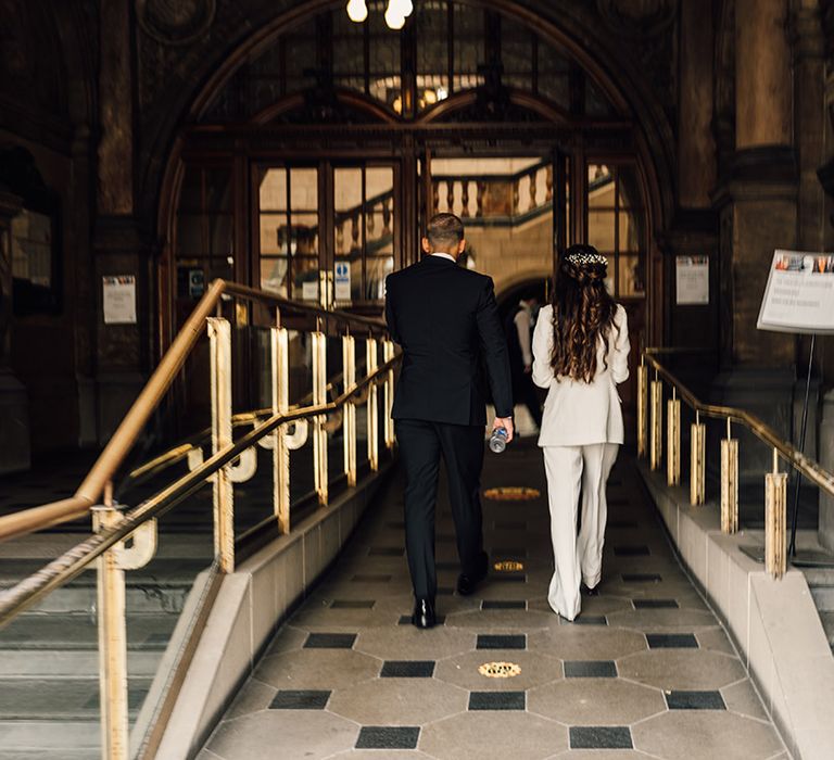 Bride and groom in black and white suits walking into their intimate Sheffield Registry Office wedding 