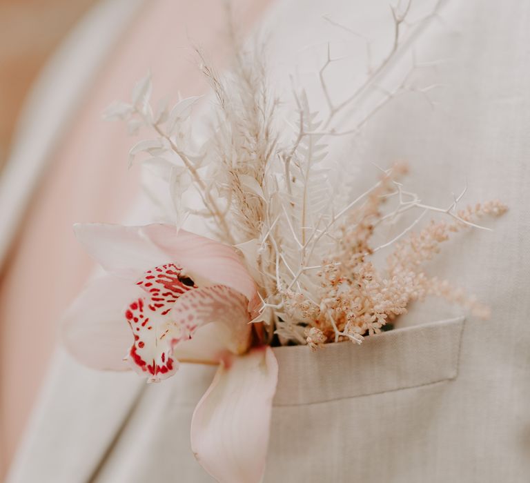 Pocket buttonhole with tropical orchid and dried flowers