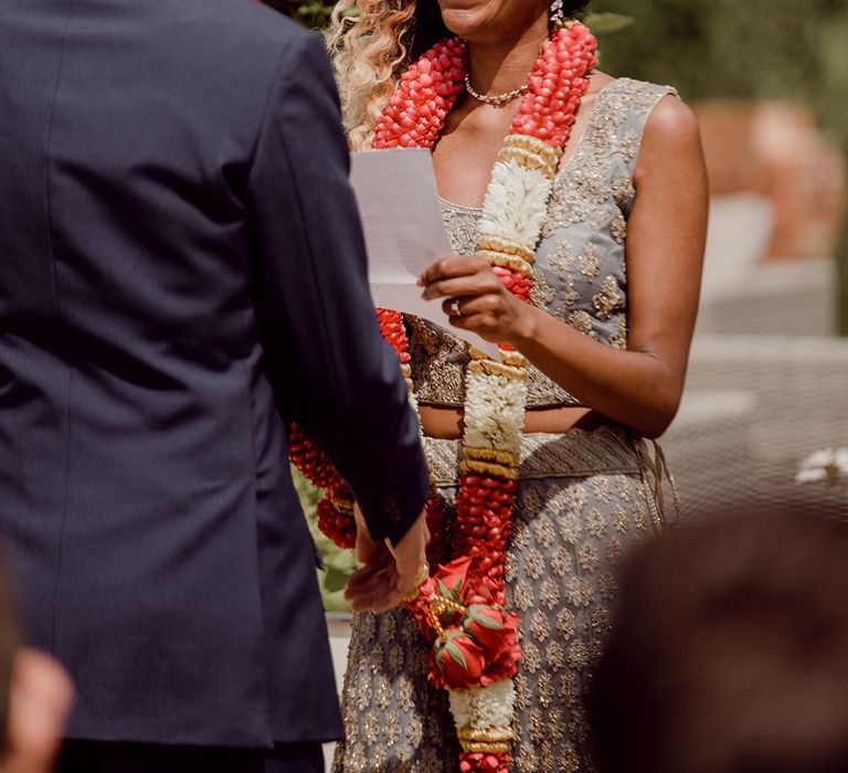 Bride looks lovingly at her groom during ceremony as she holds his hand | Joshua Gooding Photography