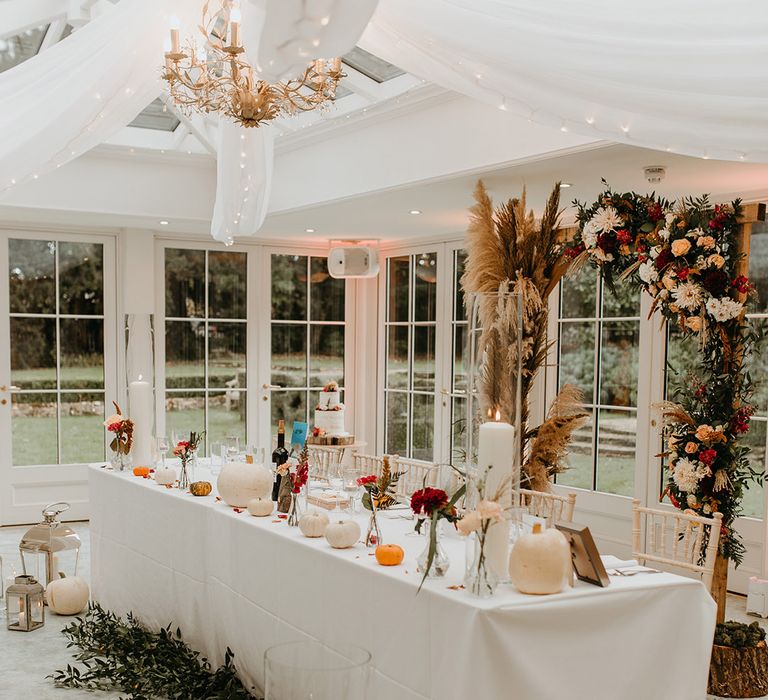 Wedding reception complete with Autumnal colour scheme and white pumpkin decoration