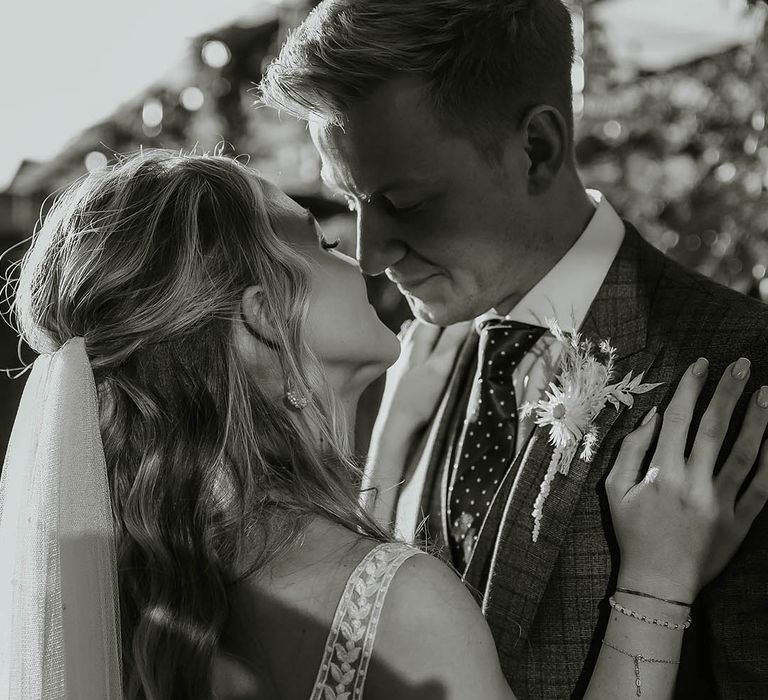 Bride in lace detail Eleganzza Sposa wedding dress with husband in check suit