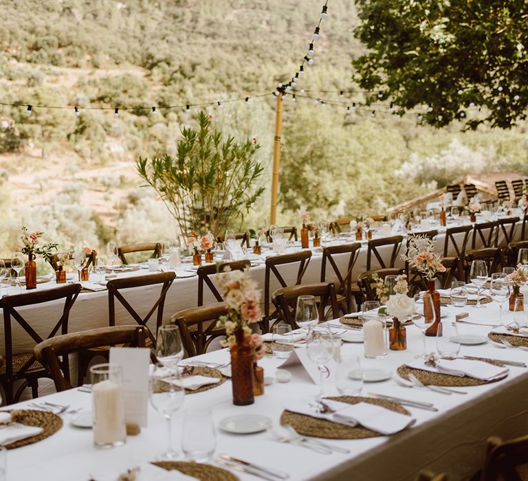 Tables are set with white and pink flowers