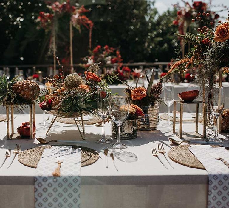 Outdoor table setting for destination wedding in South Africa with woven placemats and patterned wedding stationery