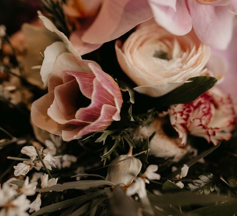 Mixed white and light pink floral bouquet with dark green foliage