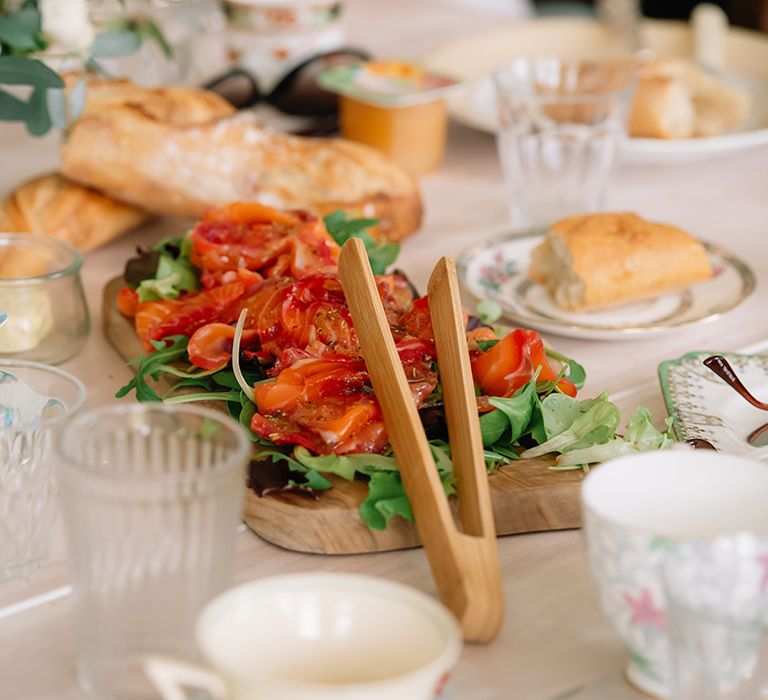 Rocket, salmon and fresh baguettes on a table for wedding guests to eat 