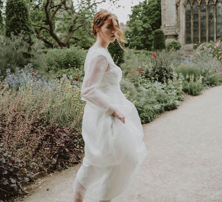 Bride in a wedding dress with long sleeves at Bishop's Palace Wells in Somerset