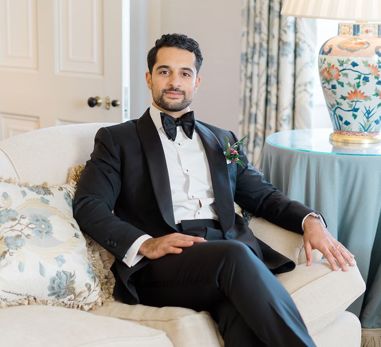 Groom wears black-tie complete with floral buttonhole 