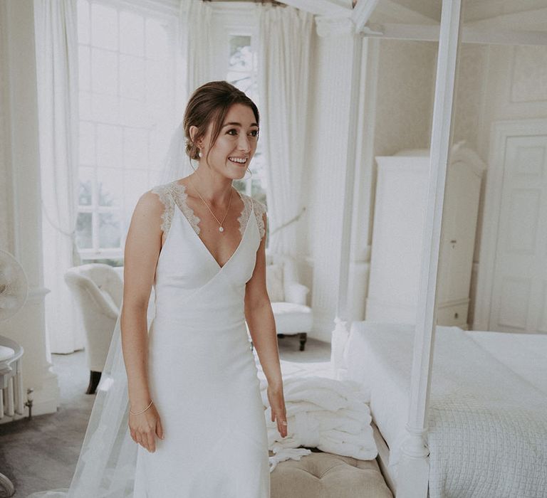 Bride wears Savannah Miller wedding dress complete with scallop edge lace to the straps 