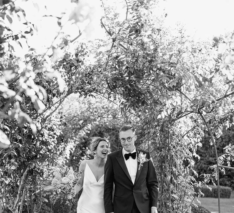 Rustic luxe Elms Barn wedding day with the bride and groom taking a stroll through the grounds for their couple portraits 