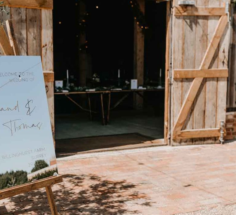 Mirrored welcome wedding sign at High Billinghurst Farm Gujarati wedding ceremony 