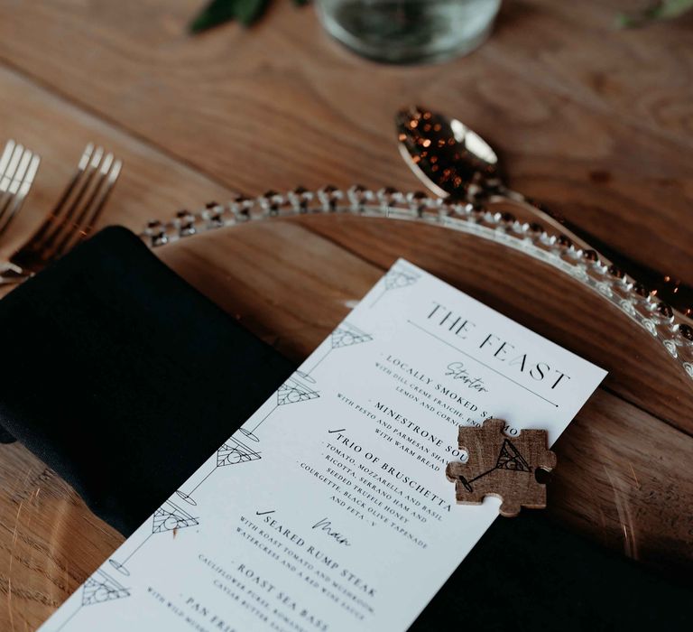 Monochrome wedding menu with puzzle piece decor and black napkin