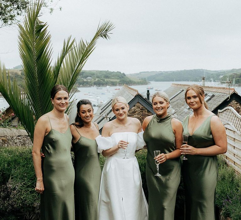 Bride in off the shoulder puff sleeve wedding dress with wedding party in satin bridesmaid dresses