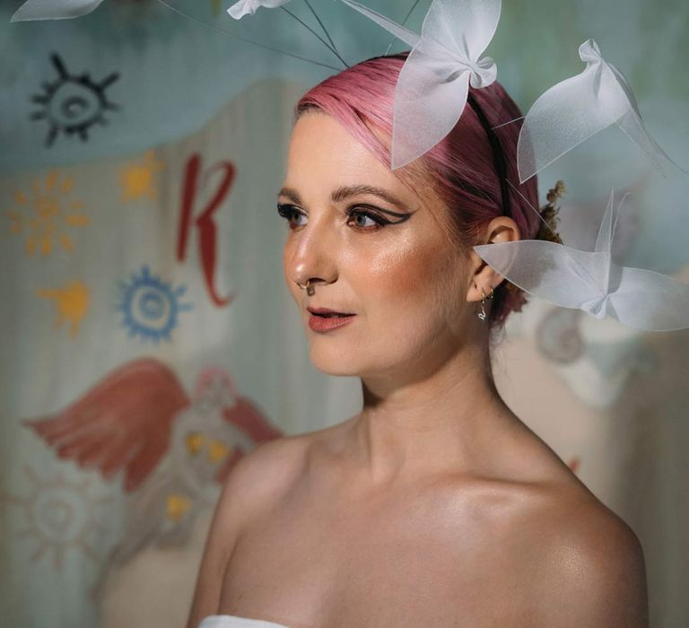 Bride in alternative artistic wedding fascinator with sheer birds