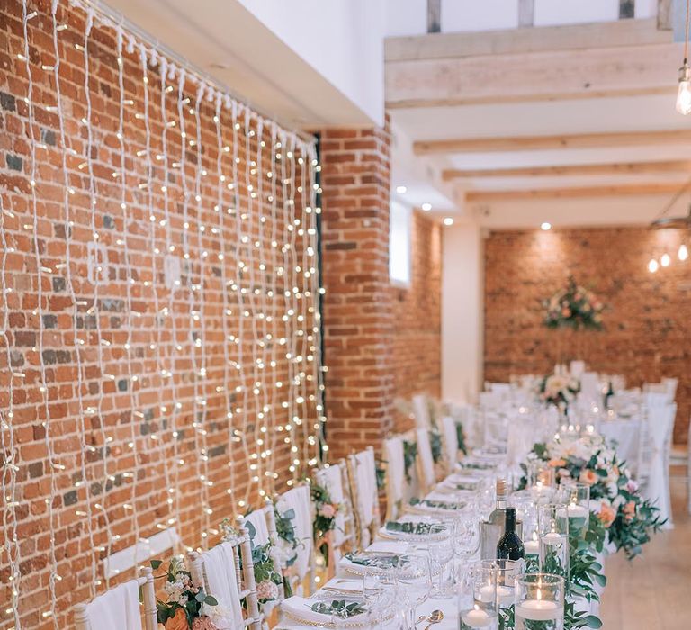 Cosy fairy lit wedding tablescape with floral centrepieces 