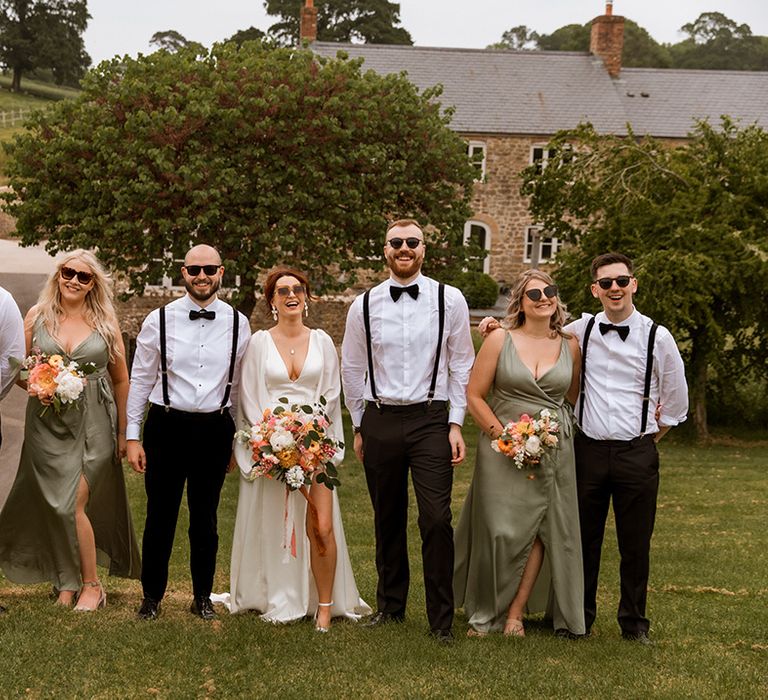 Wedding party al wearing stylish wedding sunglasses accessories for the retro theme 70s inspired wedding day 