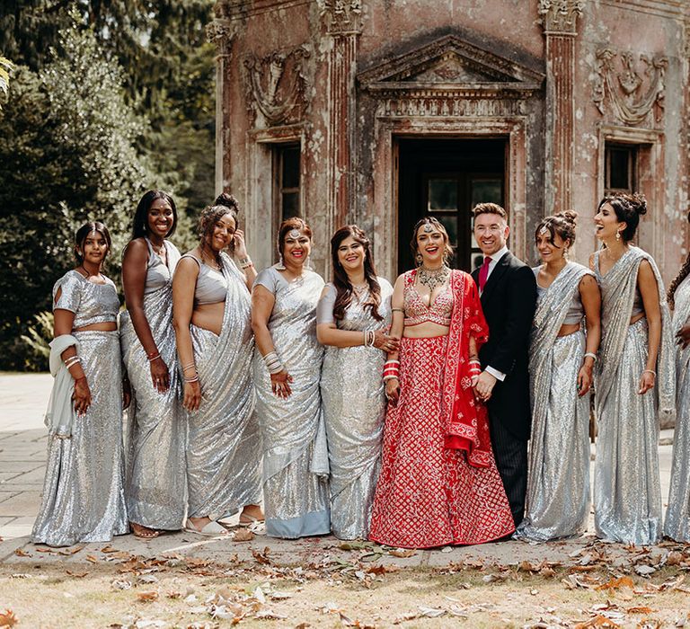 Mixed gender bridal party wearing sparkly silver metallic saris bridesmaid outfits with the man of honour 