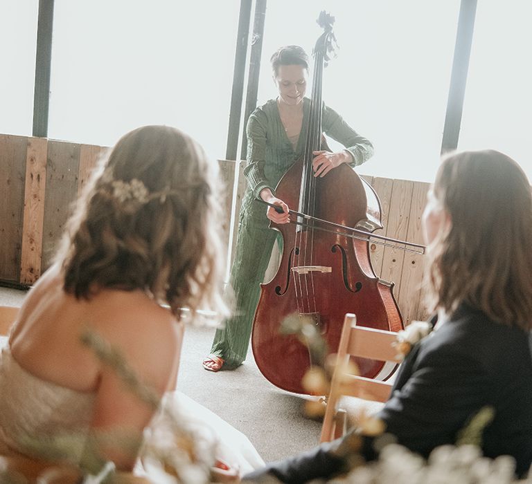 brides listing to the cellist during the Stanford Farm wedding reception 