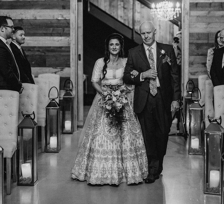 Father of the bride in navy suit walking bride down the aisle at Yorkshire wedding 