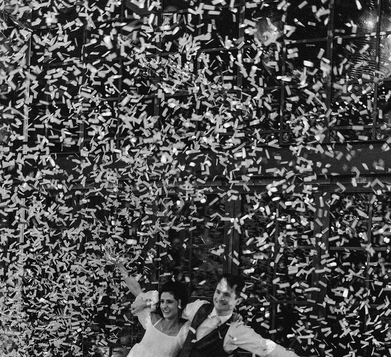 Epic confetti moment for the bride and groom as they have their first dance together 