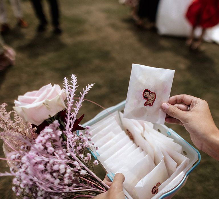 Personalised confetti pouches with a sticker of the bride and groom's face 