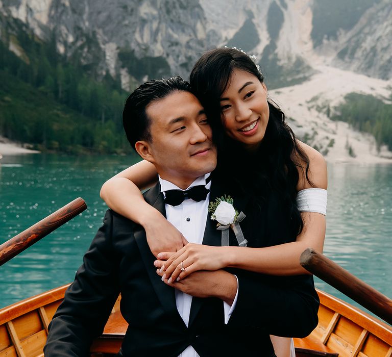 Cute couple portrait with the couple wearing black tie suit and off the shoulder wedding dress 