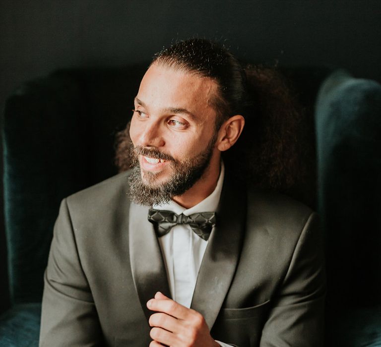 Groom wearing traditional black tuxedo for classic country house wedding 