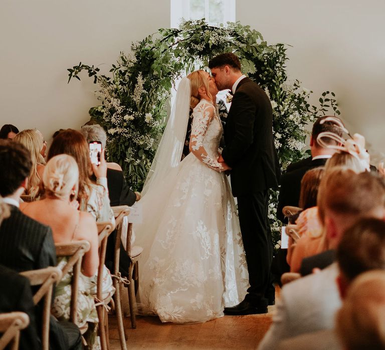 The bride and groom have their first kiss at their wedding ceremony 