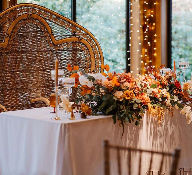 Double peacock chair for sweetheart table at boho theme wedding 