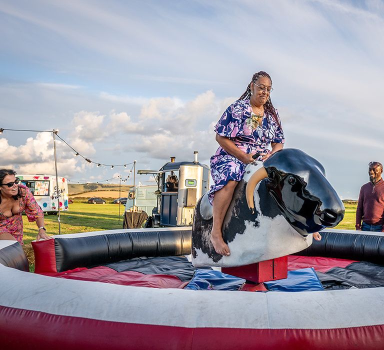 Mechanical bull riding game at festival wedding with fun carnival games