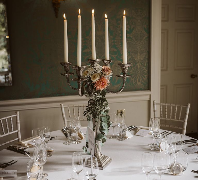 Tall candelabra wedding table centrepiece with minimalist wedding place settings and decor 