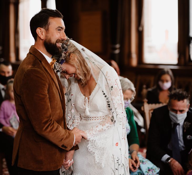 Bride embracing her groom at the altar