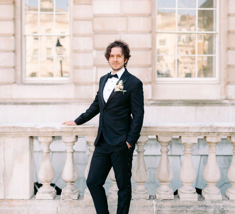 Groom wearing Topman suit for black tie wedding in London