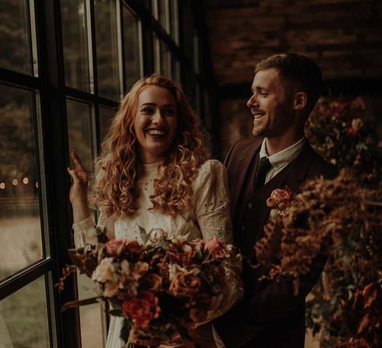 Portrait of bride and groom laughing by Esme Whiteside Photography