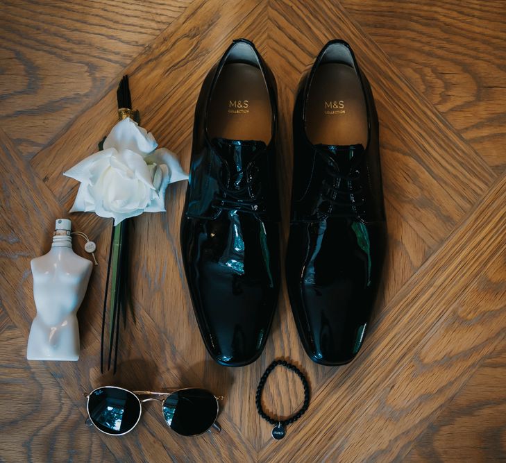 Grooms accessories including shoes, buttonhole, aftershave and sunglasses 