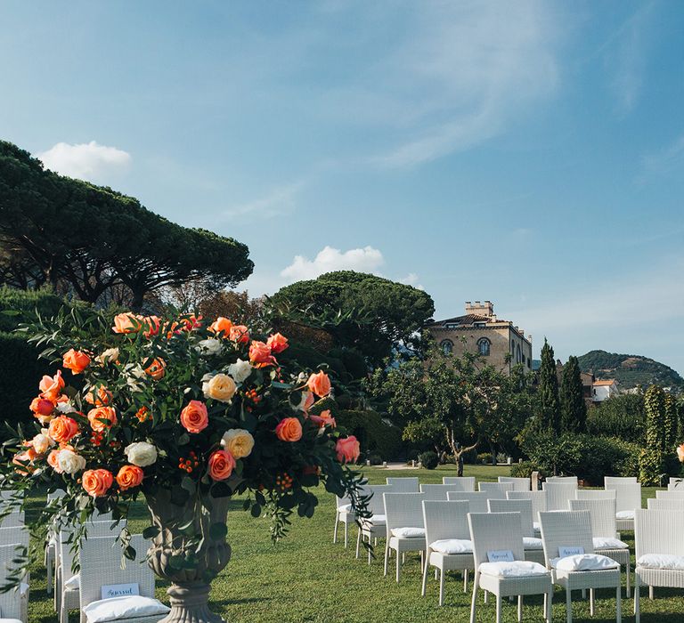 Outdoor wedding ceremony at Villa Cimbrone, Ravello, Italy with coral and peach flowers 