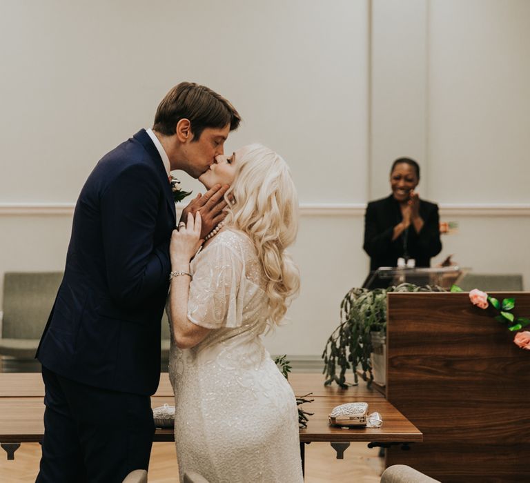 Bride & groom kiss on wedding day 