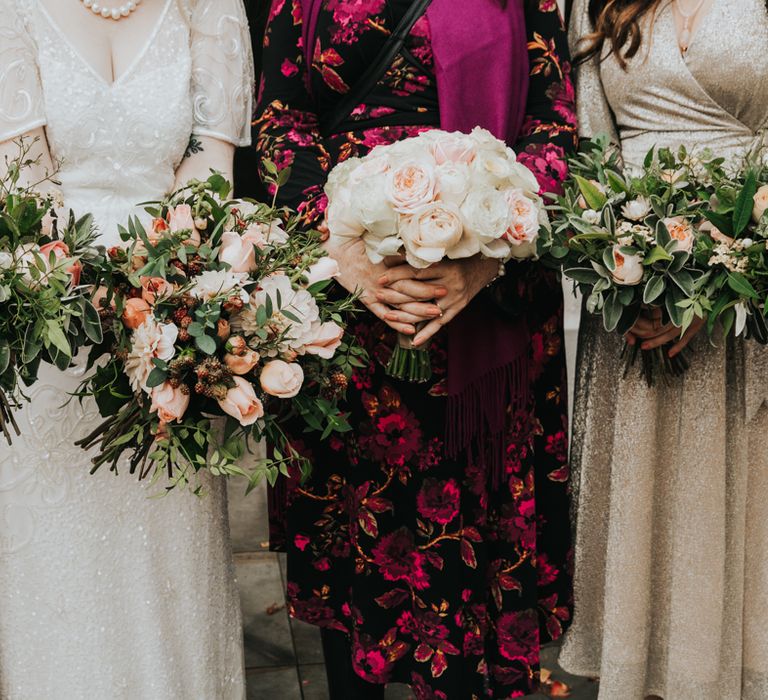 Floral bouquets featuring pale pink and white flowers with green foliage 