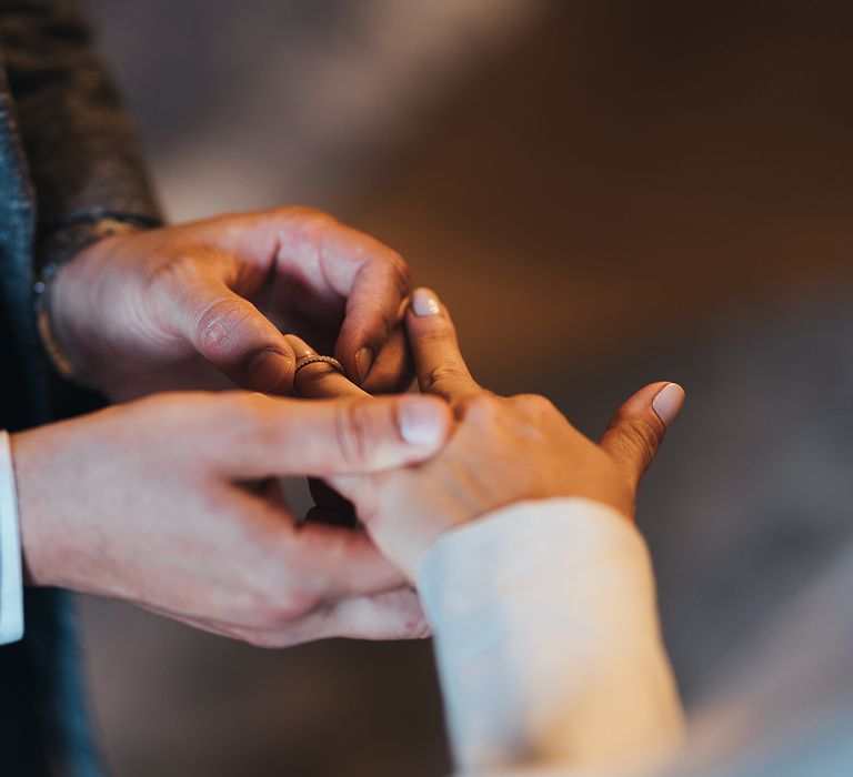 Bride and groom exchanging rings