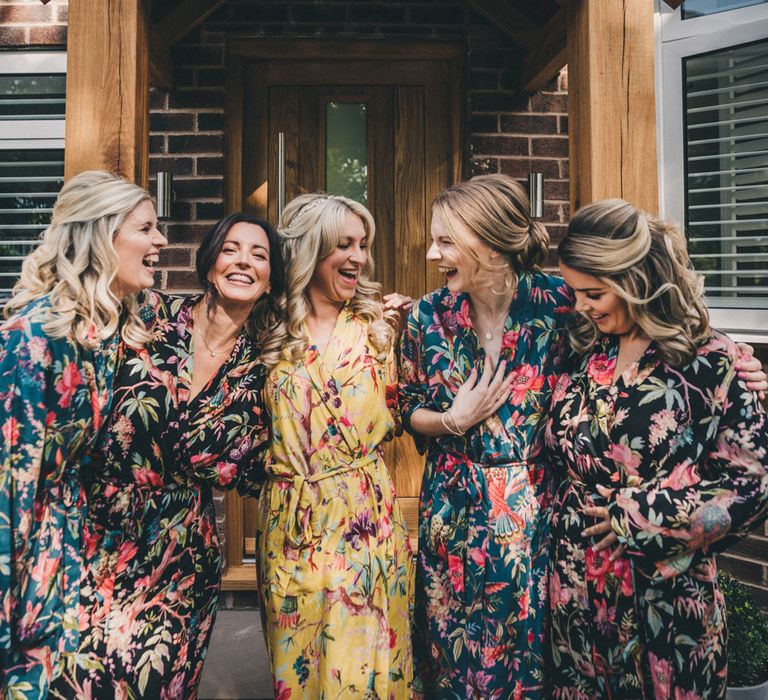 Laughing bride and bridesmaids in floral kimonos before the wedding