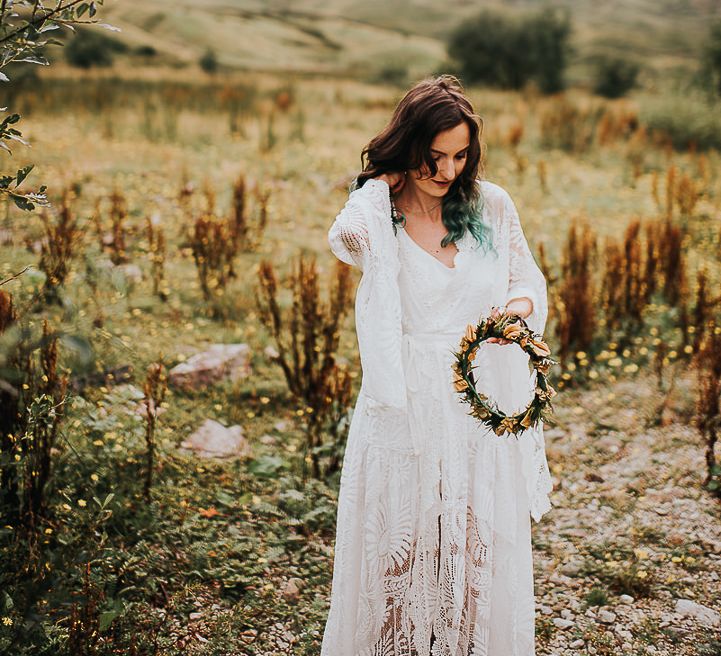 Bride carries flower crown in the Lake District