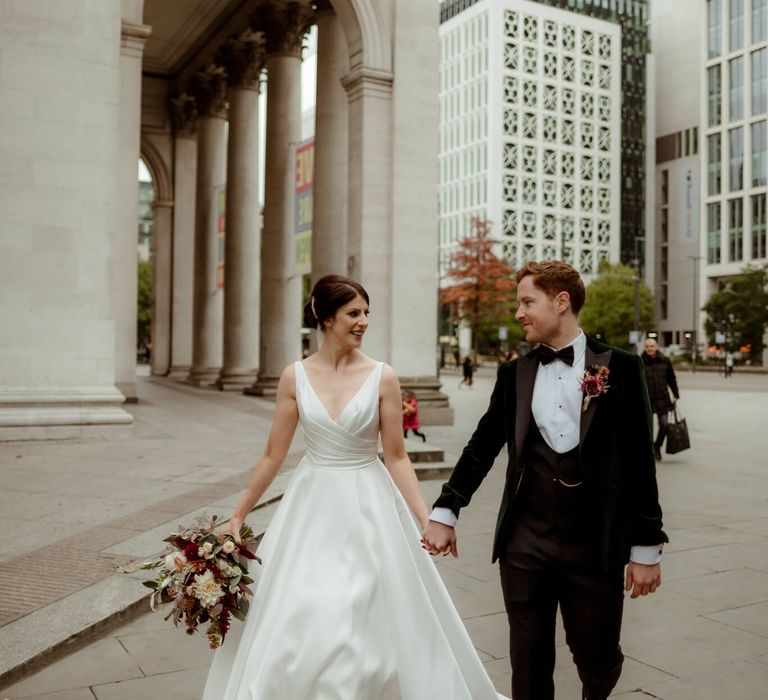 Bride and groom holding hands for Manchester townhall wedding