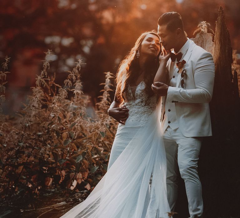 Bride looks back at groom during wedding day photoshoot