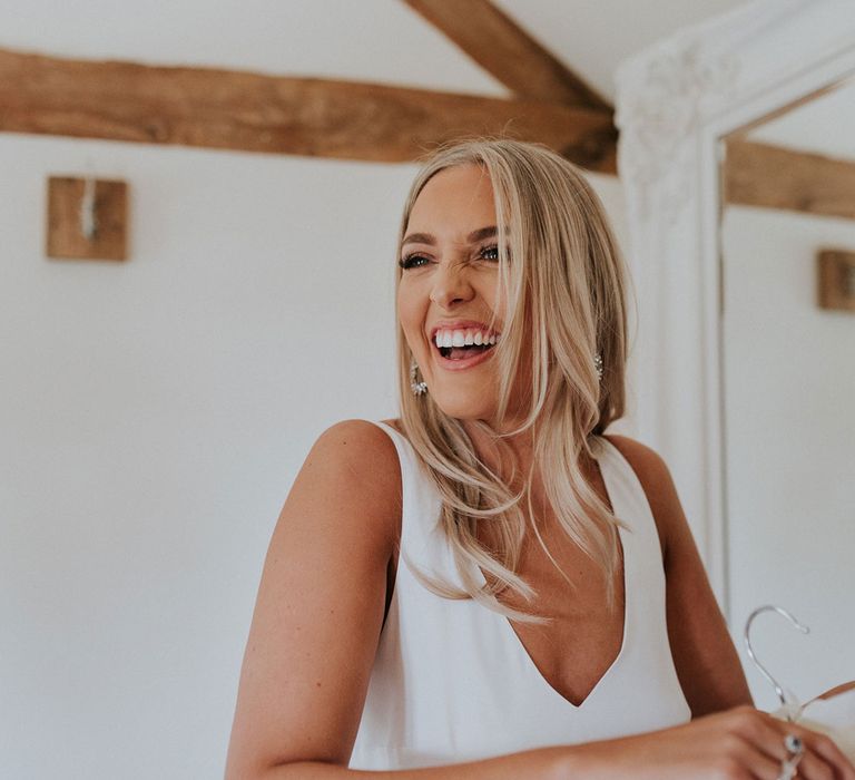 Smiling blonde bride in white Charlie Brear wedding dress at Caswell House wedding