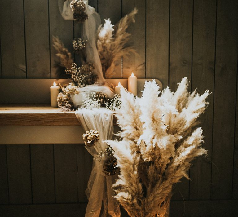 Dried pampas grass, pillar candles and linen wedding decor 