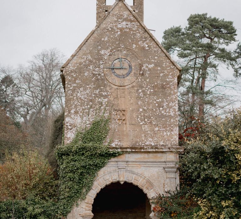 Newly wed bride and groom photography outside chapel on wedding day 