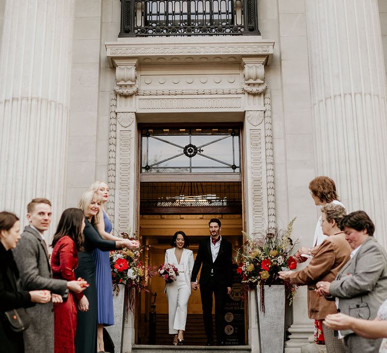 Bride & groom leave the Old Marylebone Town Hall after their wedding ceremony