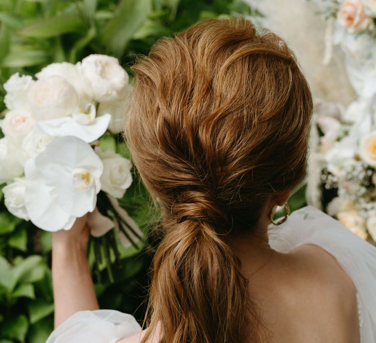 Ginger bride with relaxed waves low ponytail for boho wedding hair