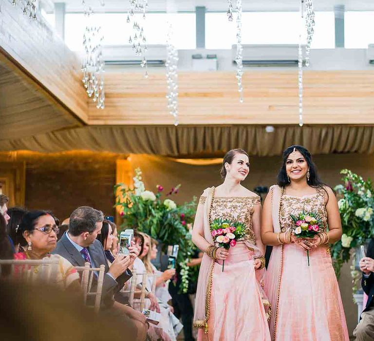 Bridesmaids walk down the aisle at Elmore Court