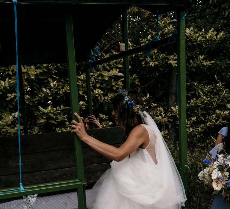 Bride climbs into tractor on the morning of her wedding day