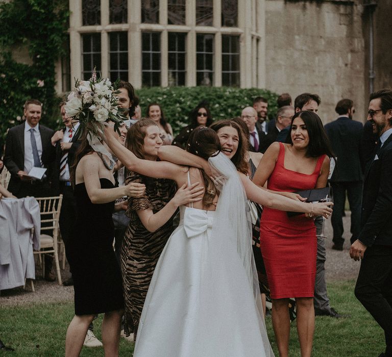 Bride goes to hug emotional friends after wedding ceremony